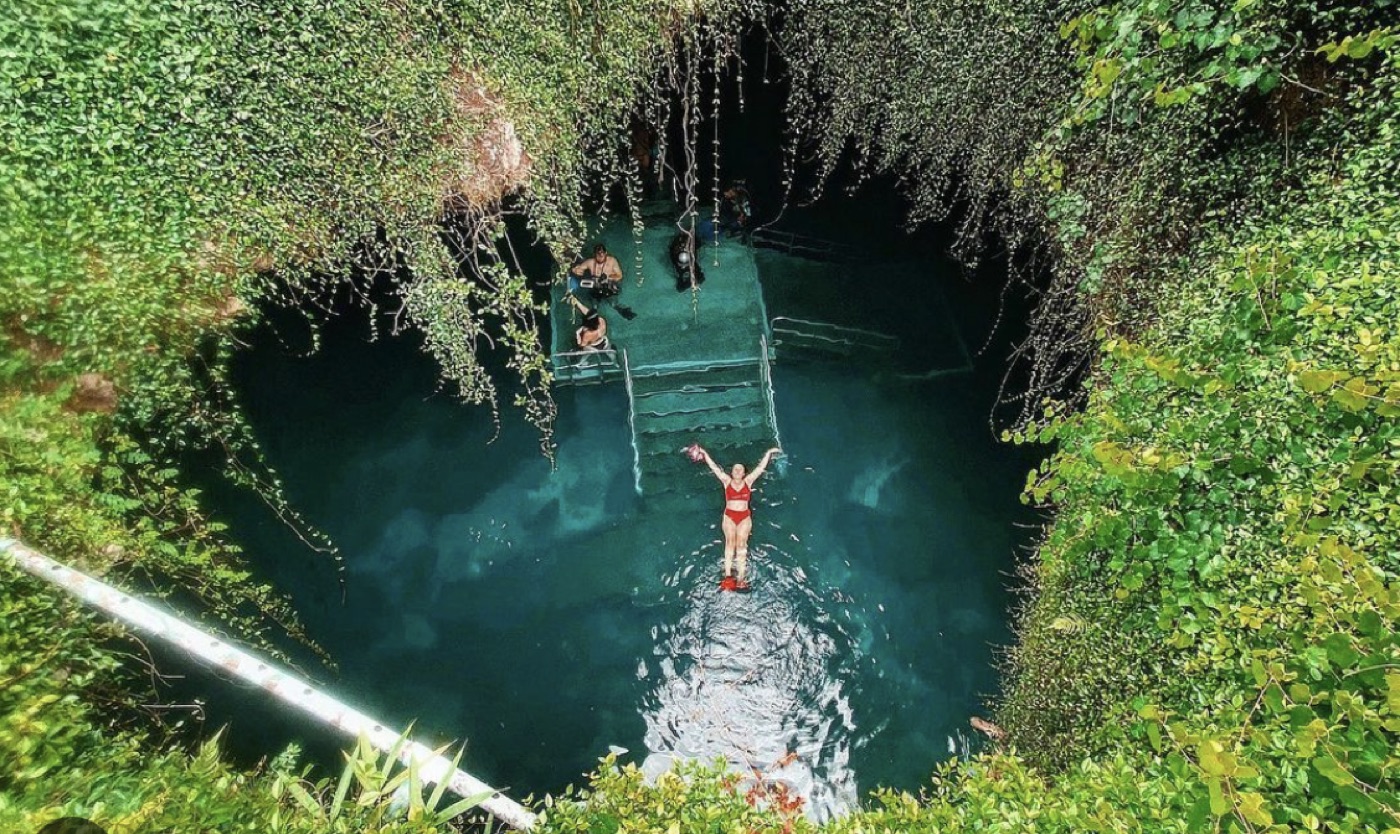 Looking down into the Devil's Den spring through the cave opening